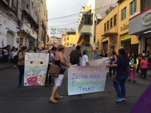 group marches in parade holding signs